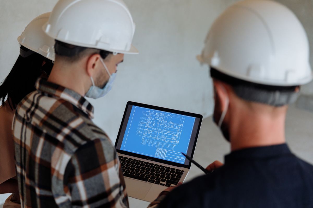 Construction team reviewing building plans